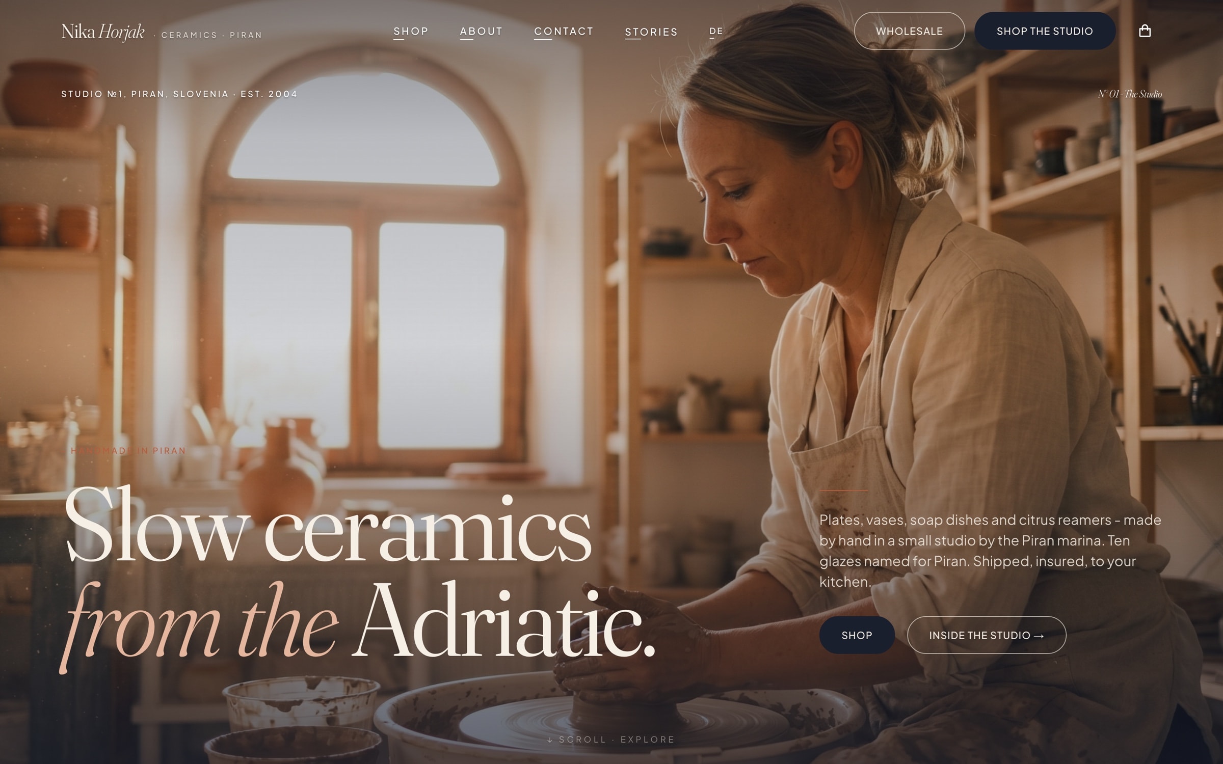 The nikahorjak.com homepage: a full-screen photograph of Nika at the potter’s wheel in her sunlit Piran studio, under the headline “Slow ceramics from the Adriatic.”